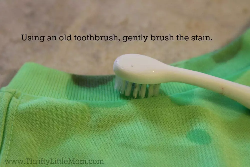 Using a toothbrush pretreat the stain