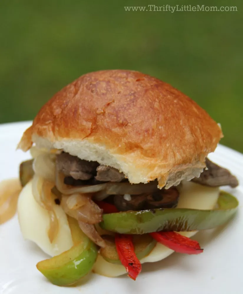 Quick and Easy Philly Cheesesteak Burger. #ad Looking for a fun new easy and affordable steak recipe for your summer celebrations? Try this delicious Philly Cheesesteak slider, burger or sandwich at your next event.