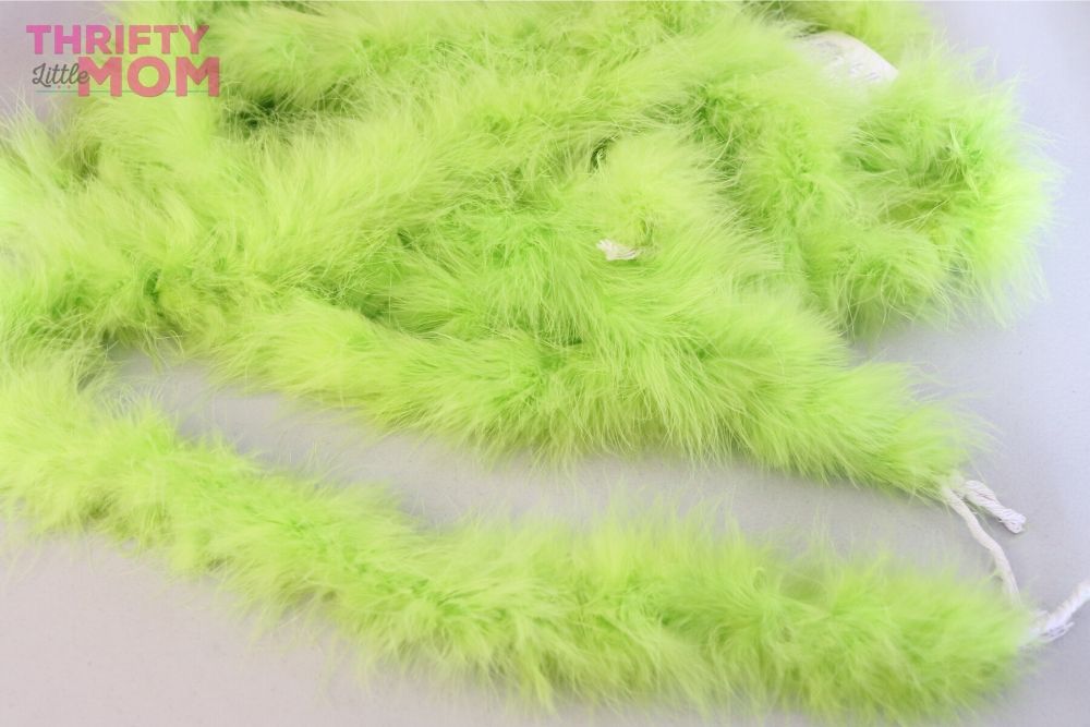 https://thriftylittlemom.com/wp-content/uploads/2019/11/grinch_christmas_tree_green_boa_wrap.jpg