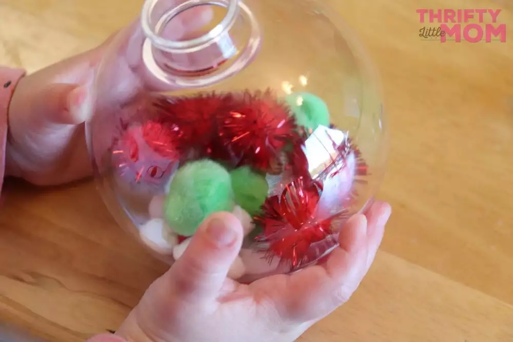 filling up the ornaments with pom poms