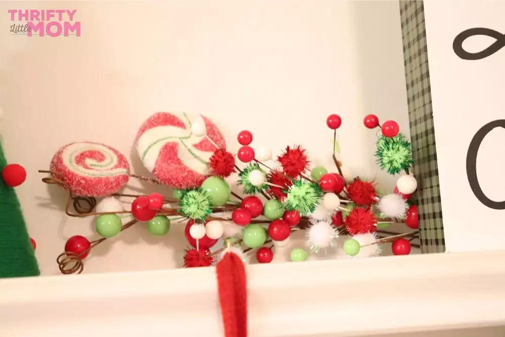 layering decorations on grinch fireplace mantle