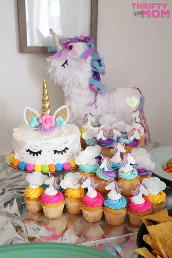 unicorn cake and cupcakes with matching balloons are perfect decoration for an 8 year old birthday party idea