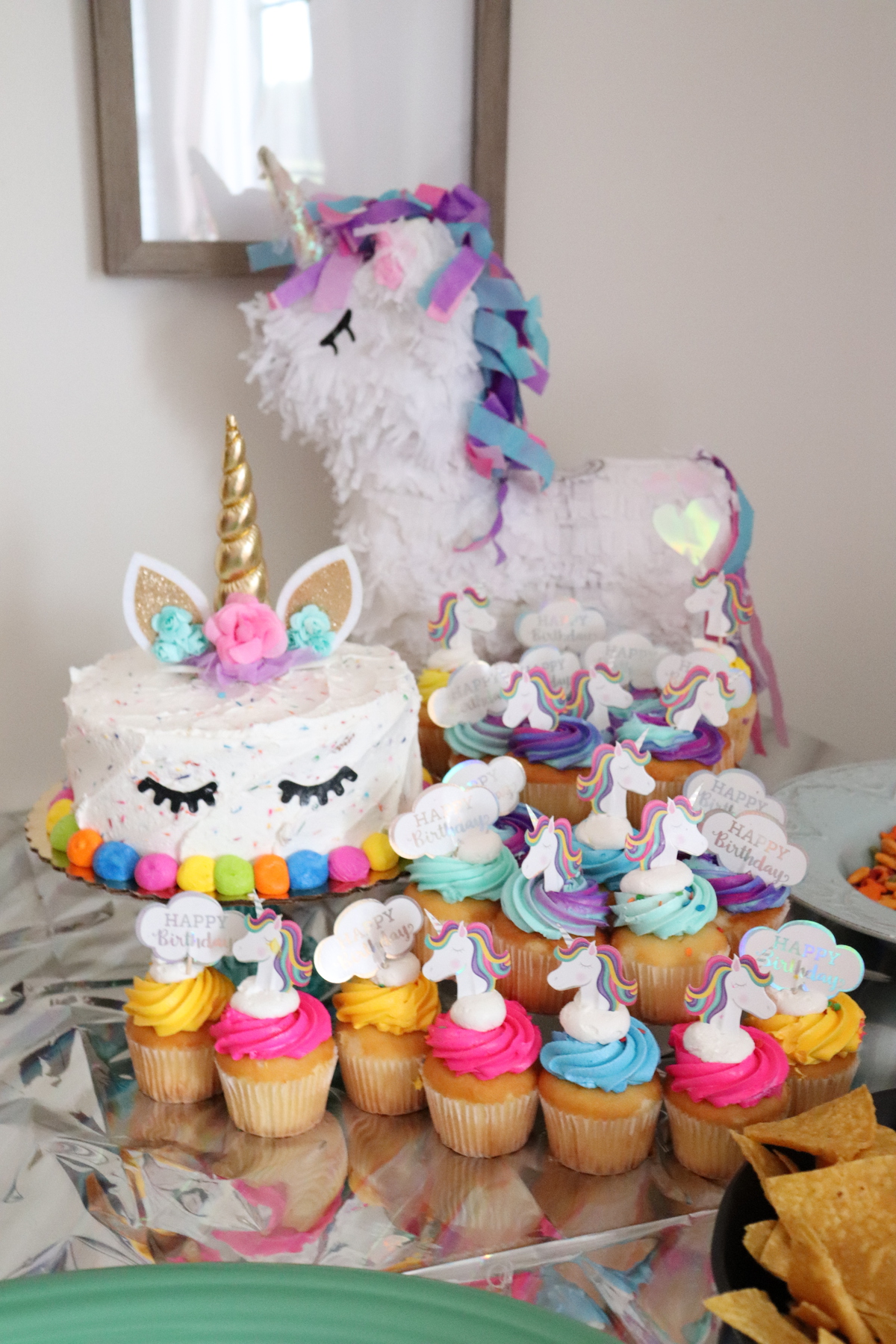 unicorn cake and cupcake with toppers cascading