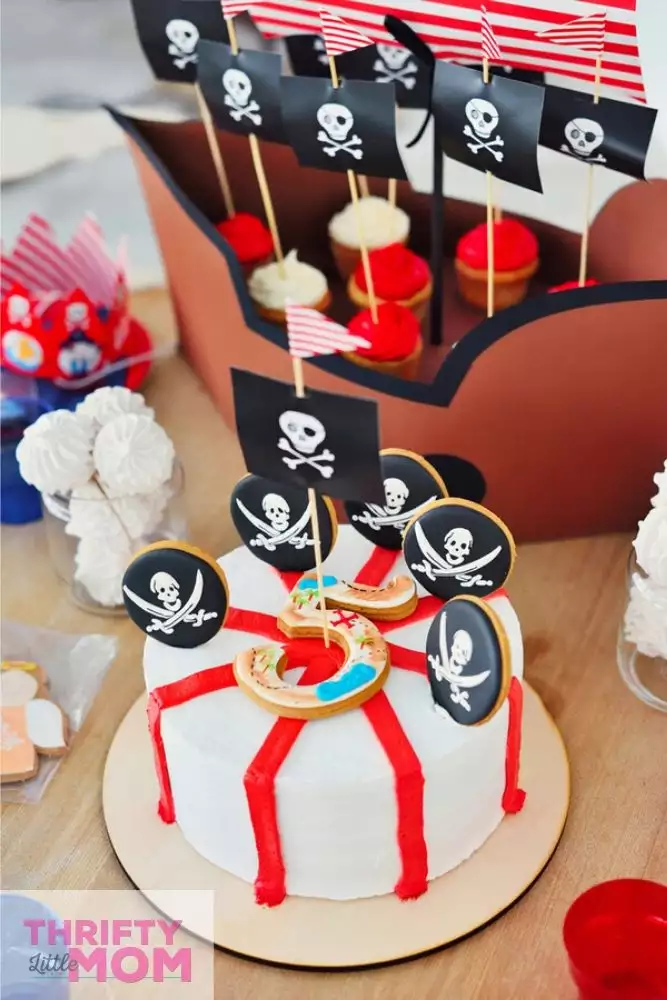 cake decorated with pirate party supplies