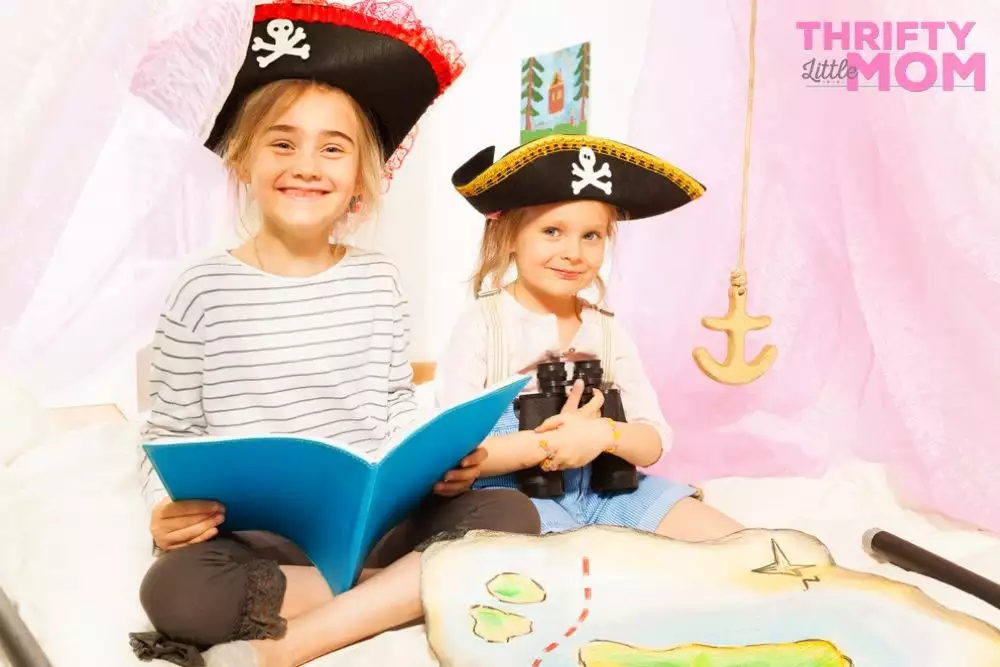 kids playing with pirate party supply treasure maps