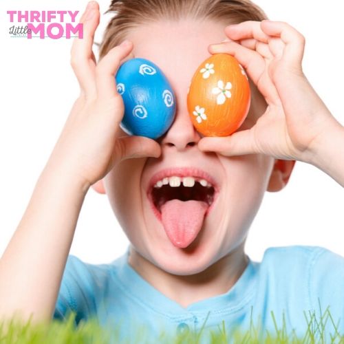kid playing with two painted eggs for easter game